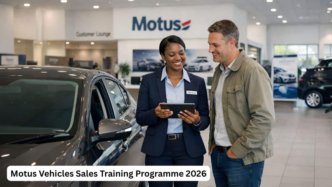 Young South African vehicle sales trainee assisting a customer in a Motus dealership showroom