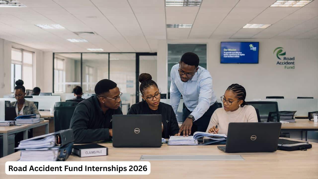 Young South African graduates receiving workplace training in a claims administration office.